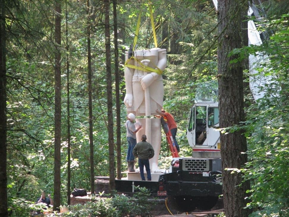 Crane installing statue torso