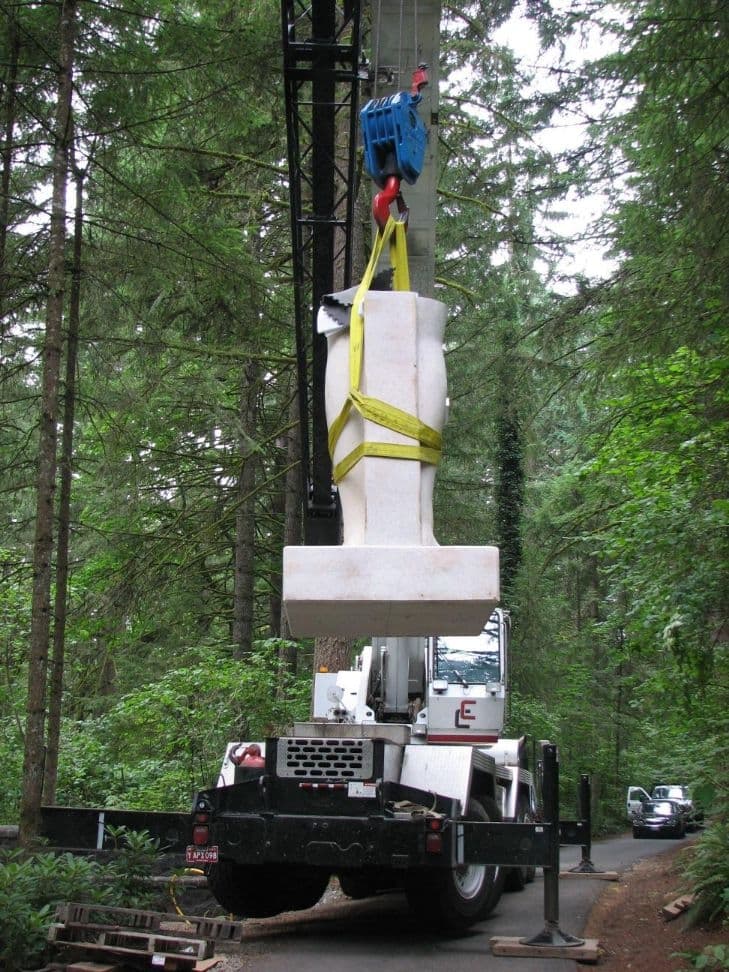 Statue section suspended above crane