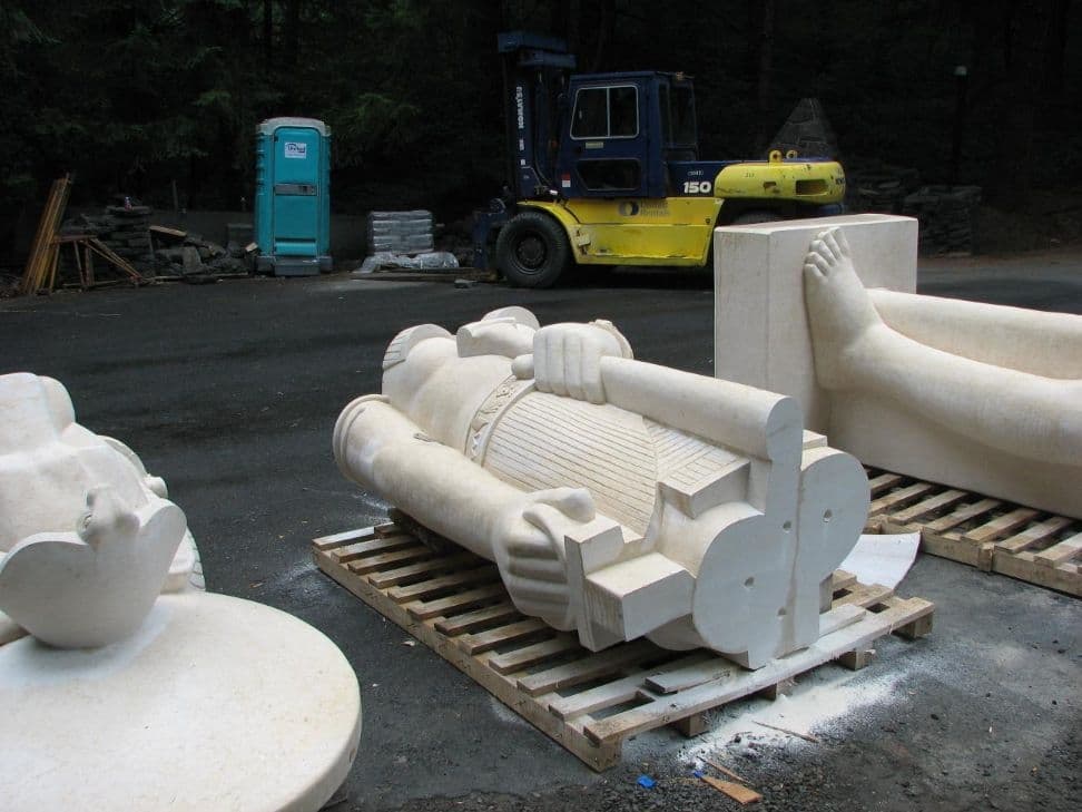 Statue torso pallet forklift behind