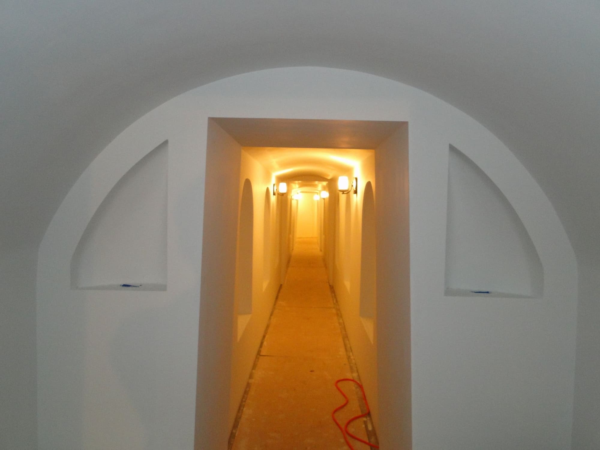 White arched hallway sconces